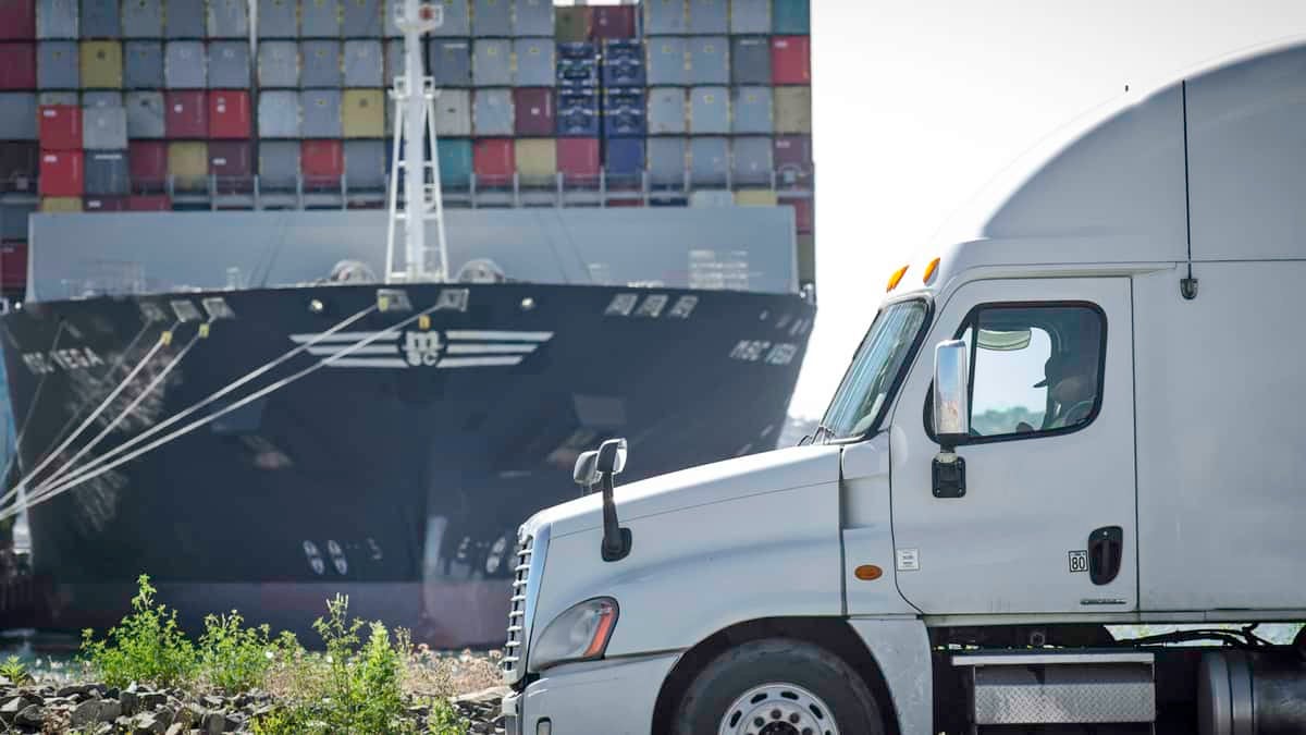 Logistics scene with truck and ship