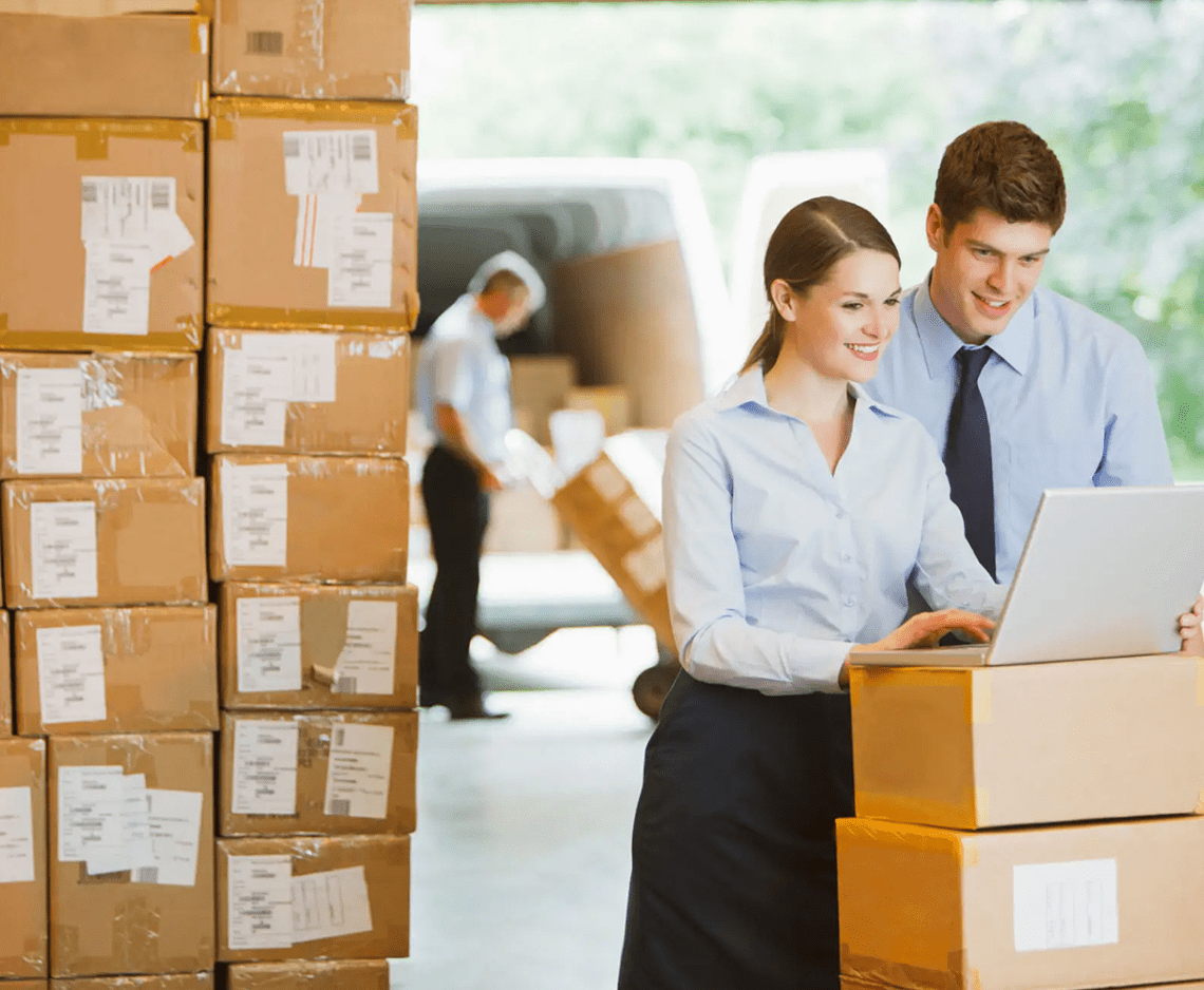Warehouse workers using a laptop