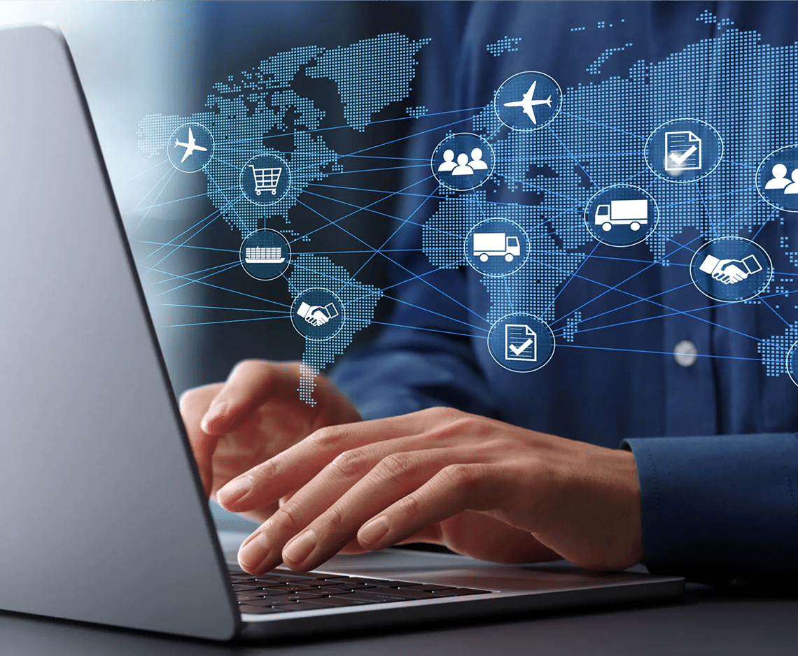 Hands typing on laptop with global icons.